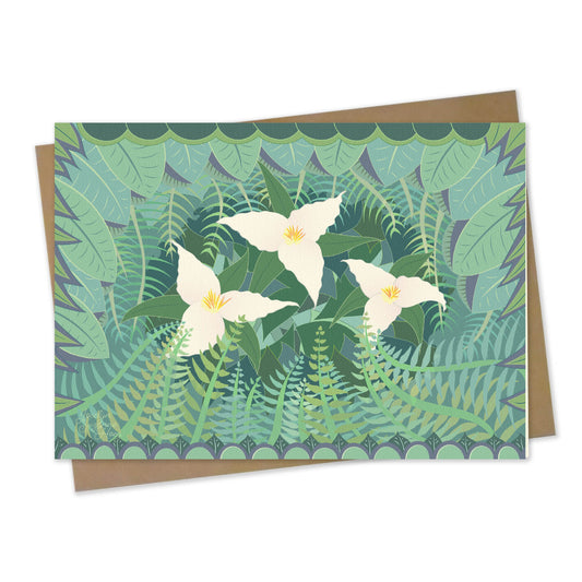 mockup for greeting card with digital design showing three flowering trillium amongst their surrounding ferns and leaves on the forest floor