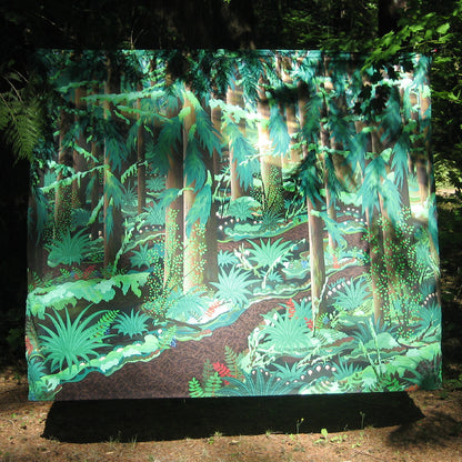 tapestry with digital design showing a trail in the forest amongst the many trees and their branches branching out as the sun selectively slips through as certain sunbeams above all the mushrooms, ferns, firs and moss